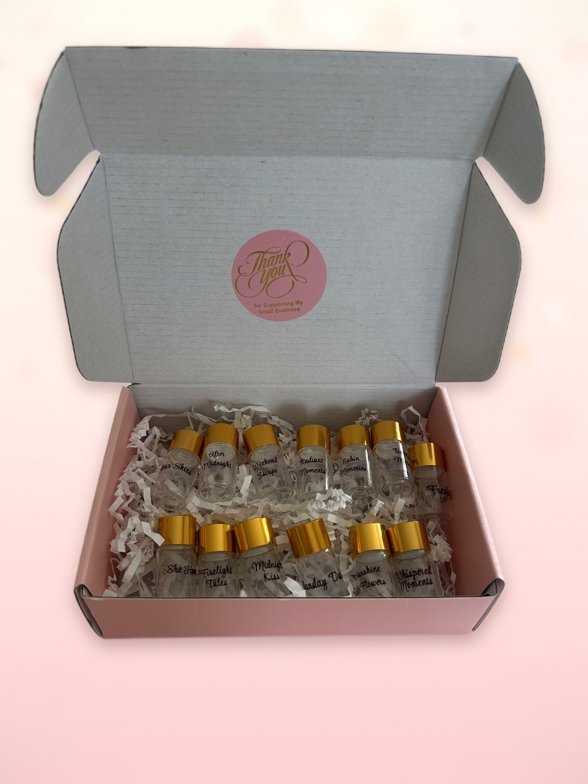 A selection of Nostaira fragrance sample vials in the presentation box